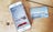 iPhone with DoorDash app open alongside a Visa Gift Card sitting on top of a wooden table