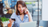 woman on phone checking five back balance